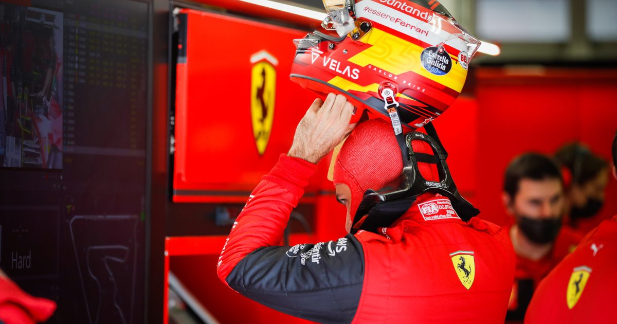 Carlos Sainz putting on his helmet. Bahrain March 2022