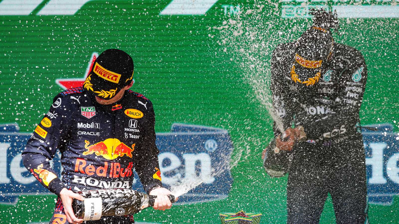 Lewis Hamilton and Max Verstappen celebrate on the podium. Brazil, November 2021.