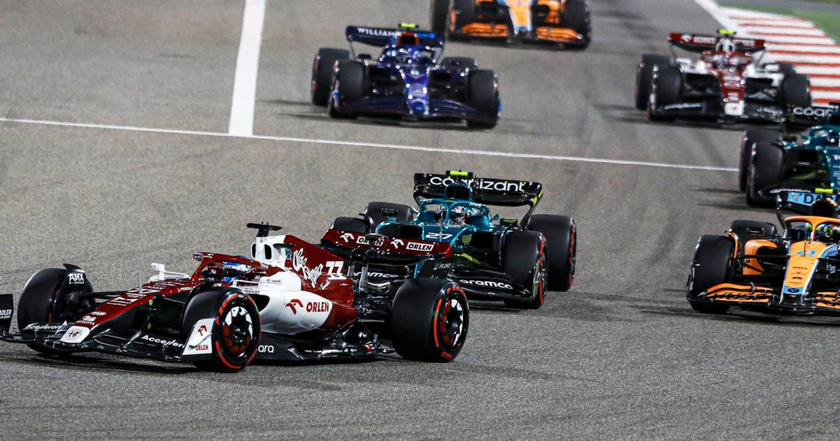 A group of cars follow Alfa Romeo's Valtteri Bottas. Bahrain March 2022.