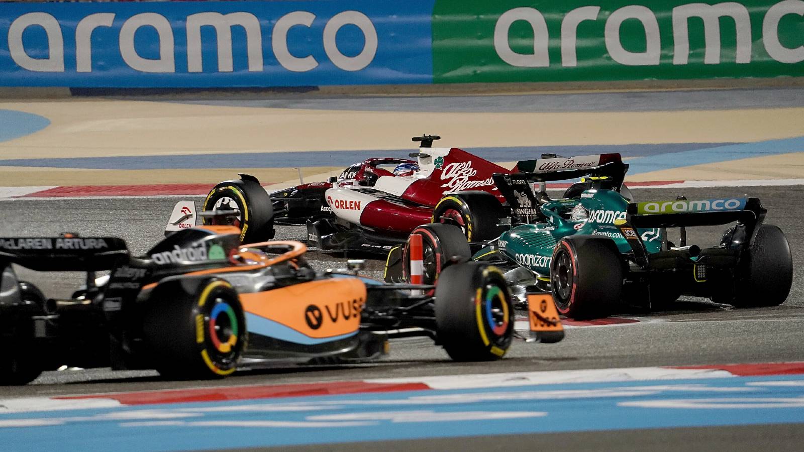 A McLaren and an Aston Martin follow an Alfa Romeo. Bahrain March 2022.