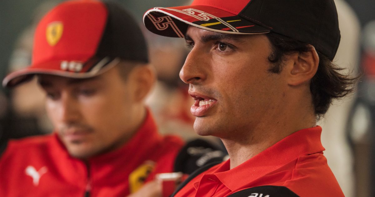 Carlos Sainz speaking with Charles Leclerc in the background. Bahrain March 2022