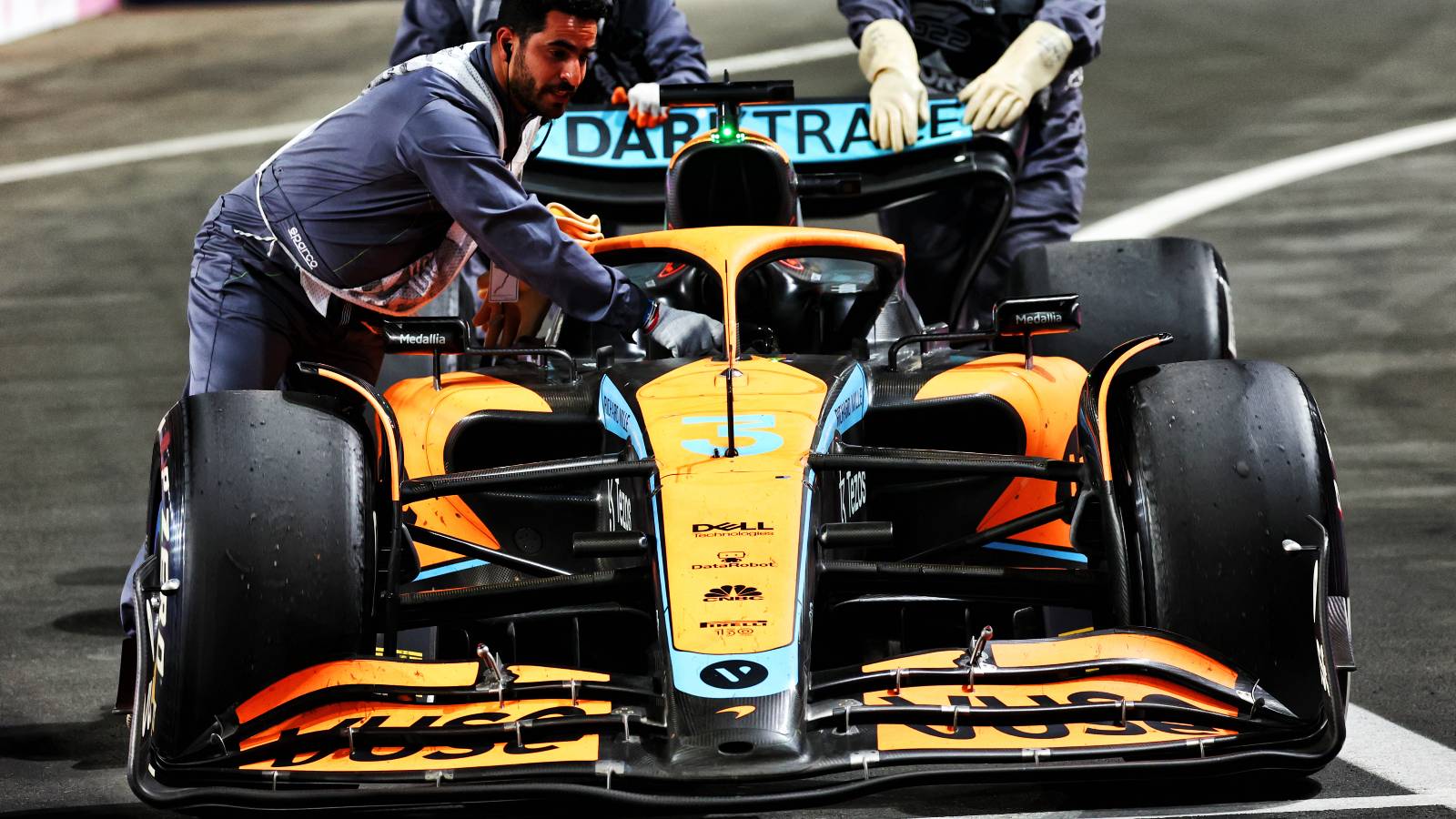 Daniel Ricciardo's McLaren is pushed into the pit lane. Saudi Arabia March 2022.