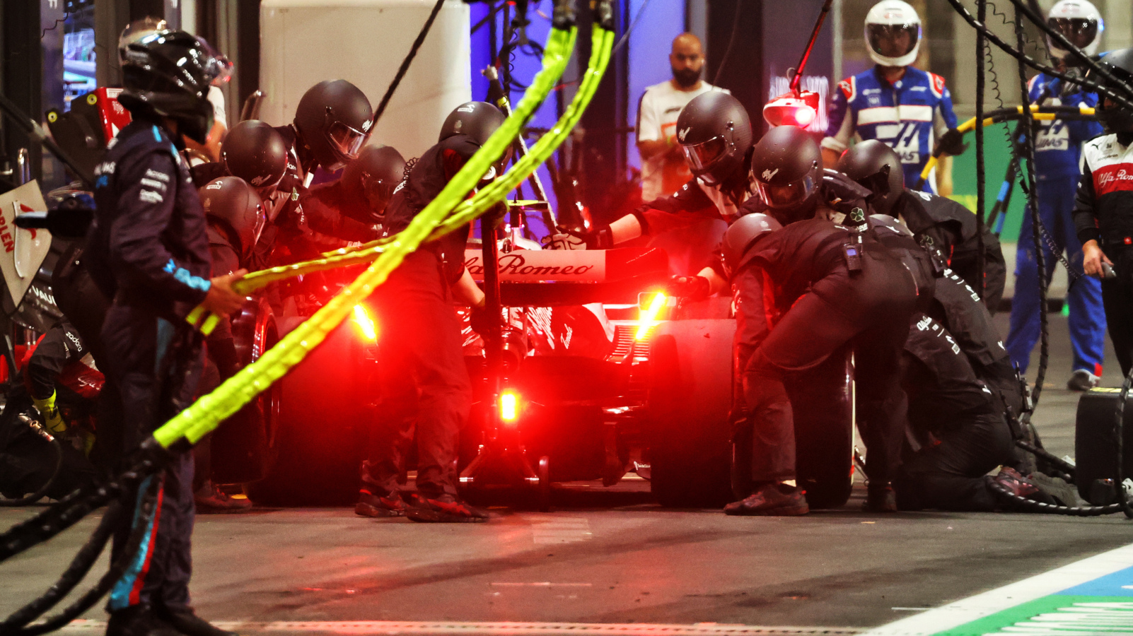 Guanyu Zhou and Alfa Romeo pit stop at night. Saudi Arabia March 2022