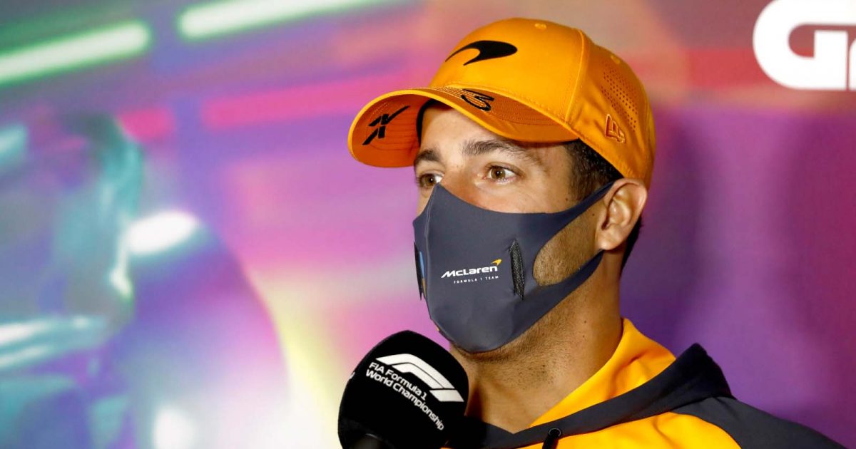 Daniel Ricciardo holds a mic. Saudi Arabia March 2022.