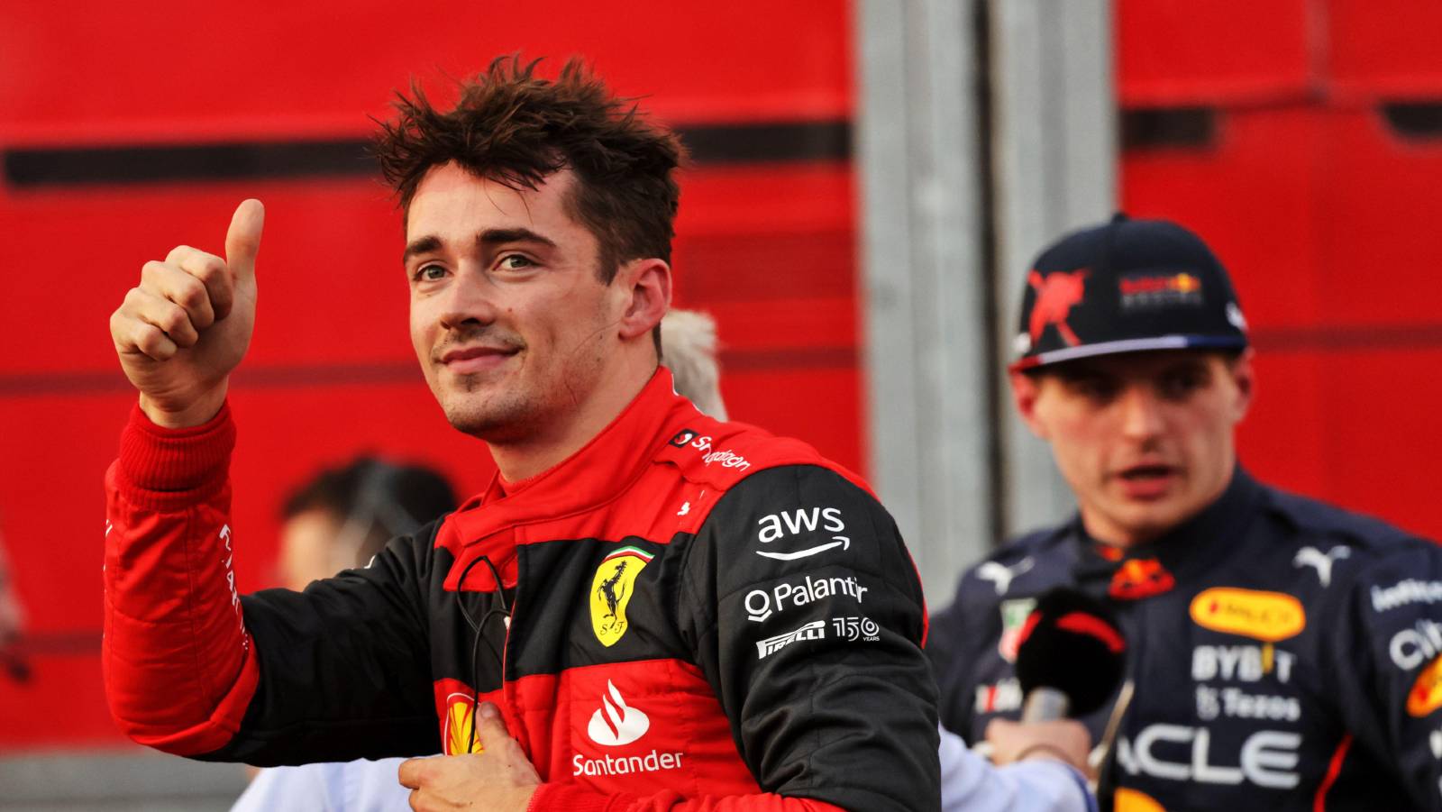 Charles Leclerc gives the thumbs-up, with Max Verstappen in the background. Melbourne April 2022.