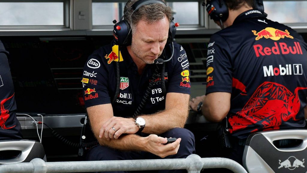 Christian Horner looking at his phone on the pit wall. Melbourne April 2022.