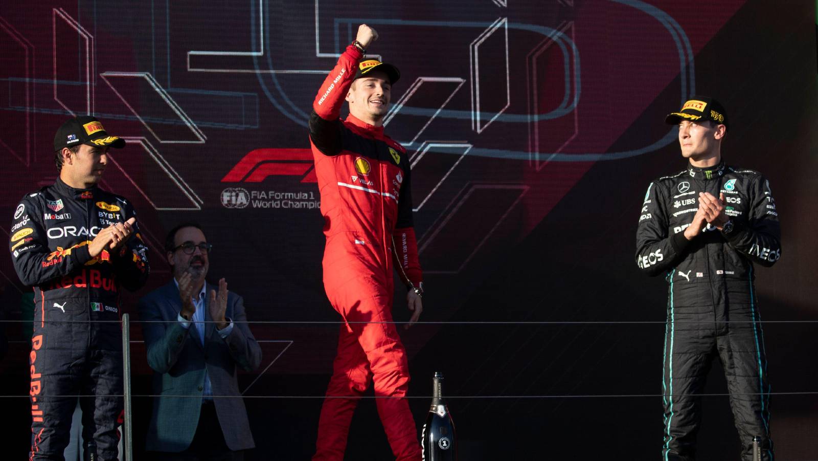 Charles Leclerc, arm raised on the podium. Australia, April 2022.
