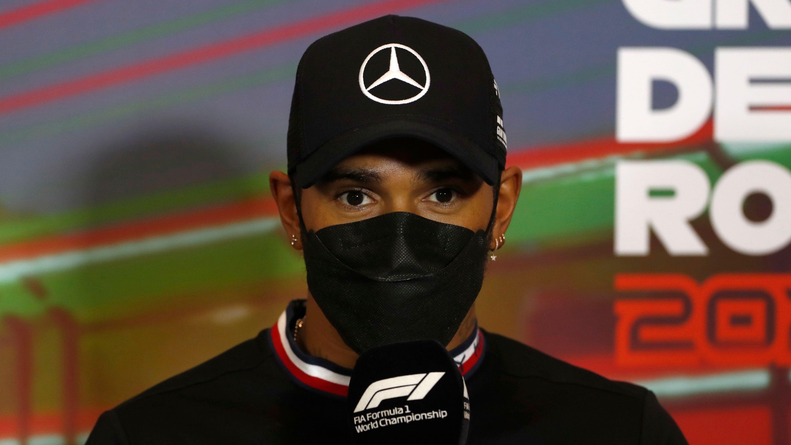 Lewis Hamilton holds a microphone. Imola, April 2022.