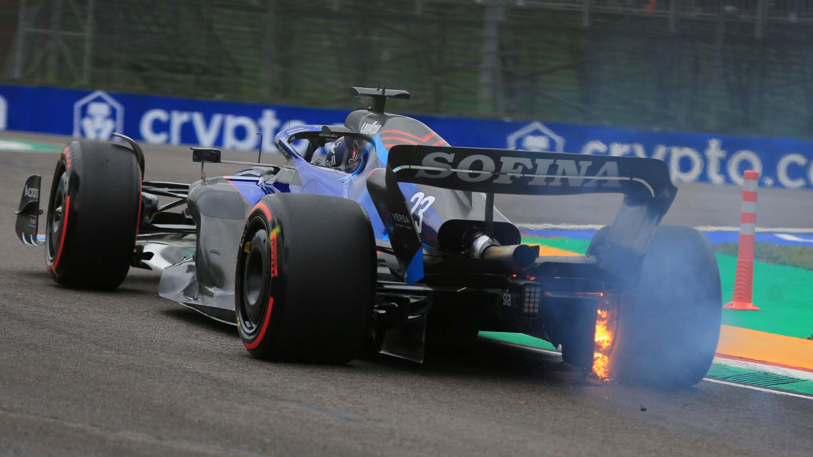 Alex Albon drives with a brake on fire. Imola April 2022.