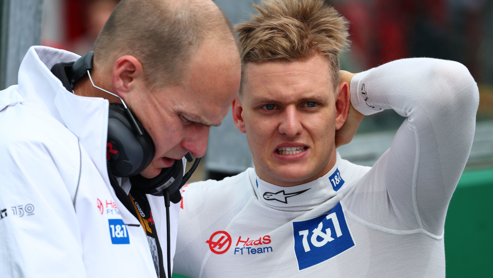 Mick Schumacher yikes with engineer Gary Gannon on the grid. Imola April 2022