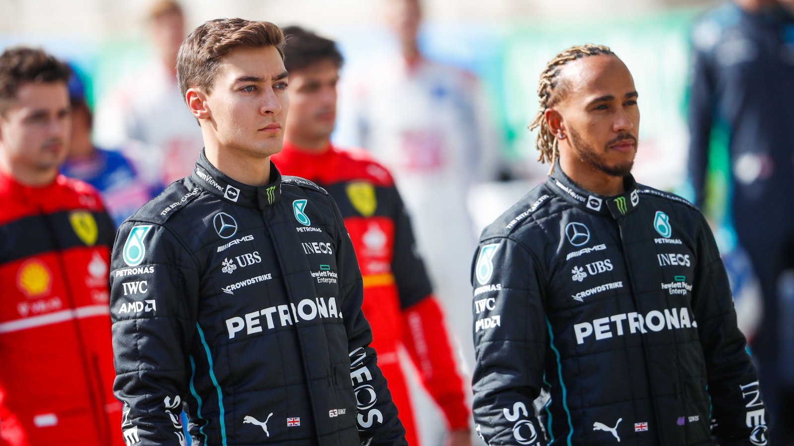 George Russell standing next to Lewis Hamilton. Sakhir, Bahrain, March 2022.
