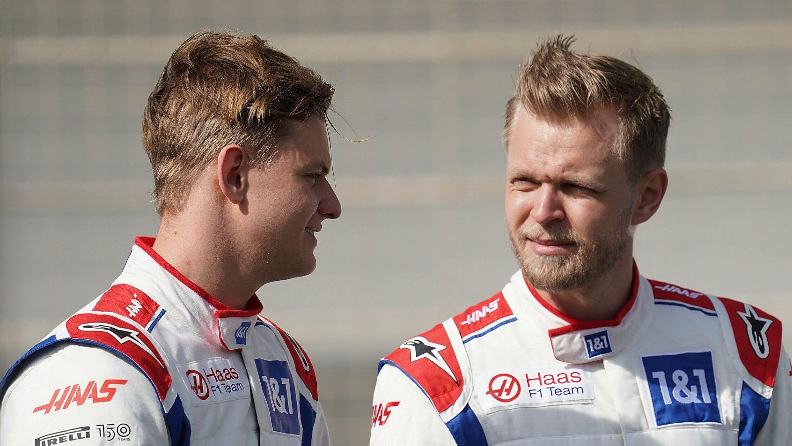 Kevin Magnussen listens as Mick Schumacher speaks to him. Bahrain, March 2022.