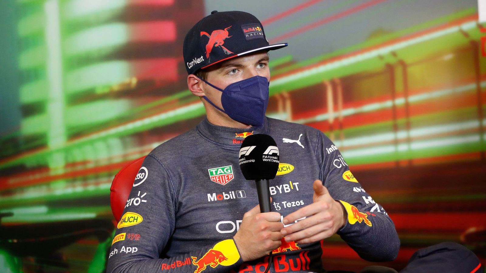 Max Verstappen speaks into a microphone. Imola, April 2022.