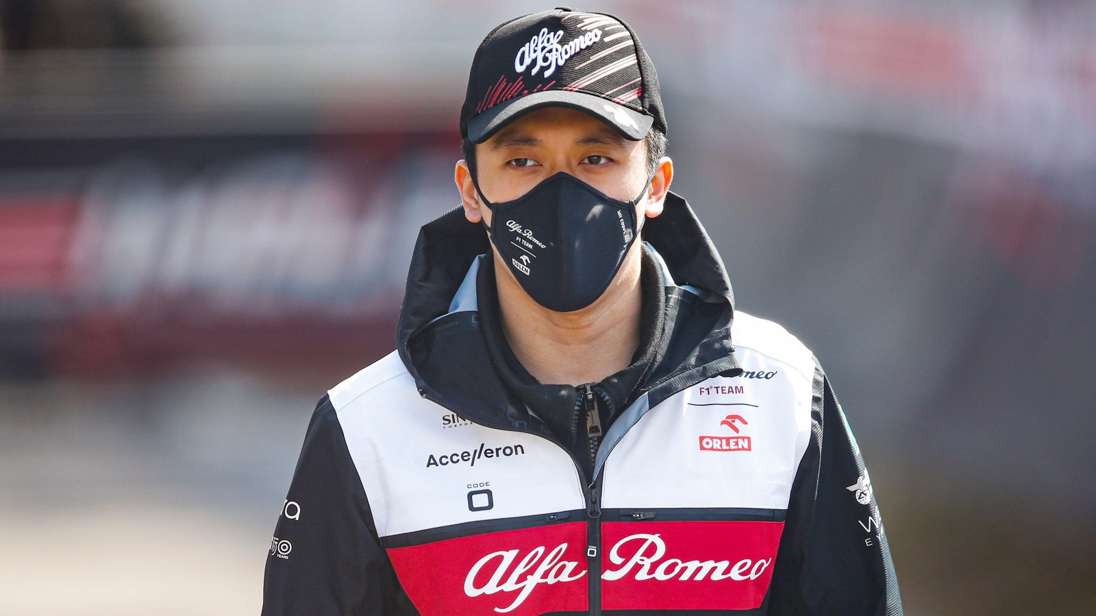 Guanyu Zhou wearing a mask and hat. Imola, April 2022.