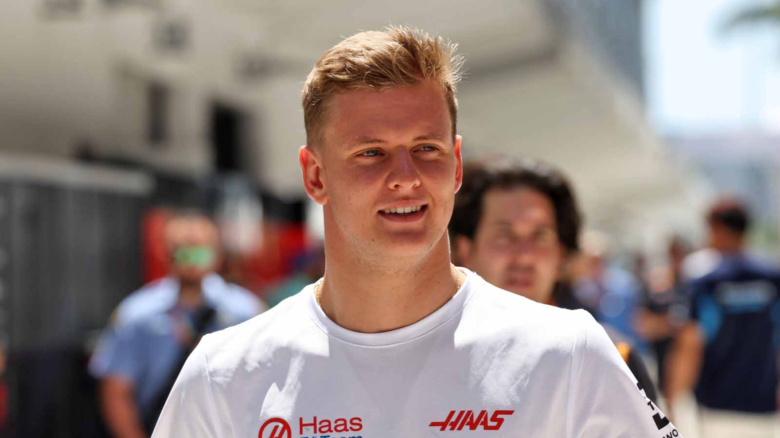 Mick Schumacher smiles in the paddock. Miami May 2022.