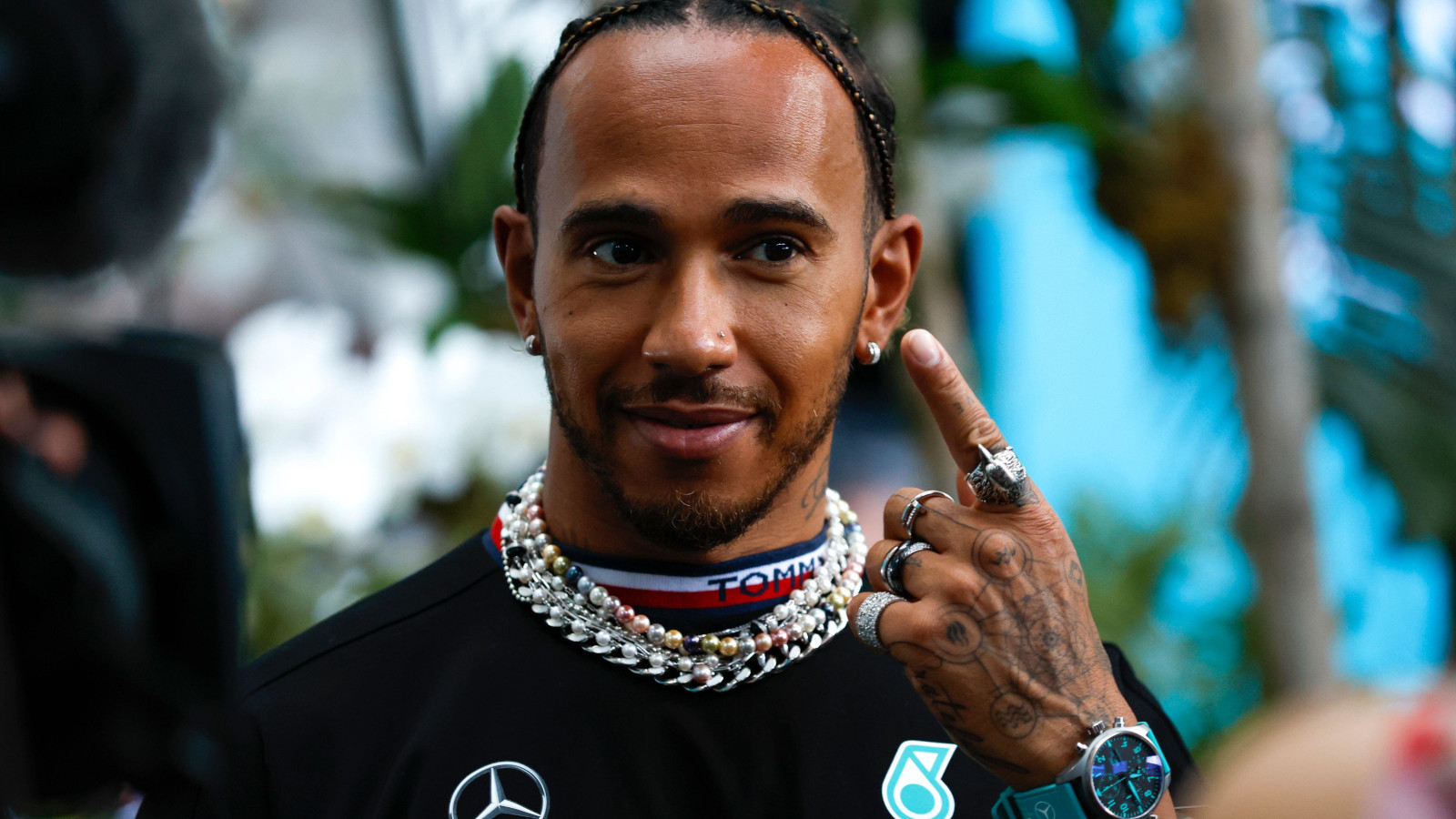 Lewis Hamilton points to his earrings. Miami May 2022