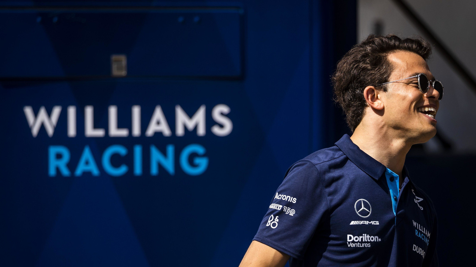 Nyck de Vries smiling with the Williams signage behind him. Spain May 2022