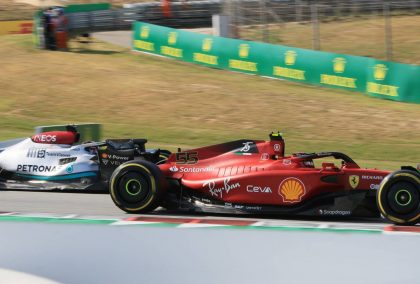 Carlos Sainz, Ferrari, passes George Russell, Mercedes. Spain, May 2022.