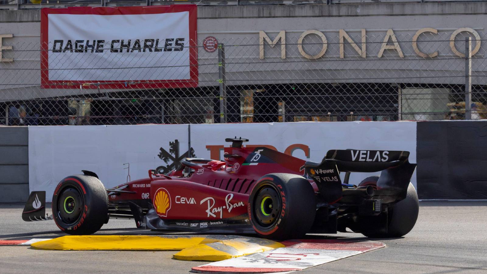 Charles Leclerc drives past a banner dedicated to him. Monte Carlo May 2022.