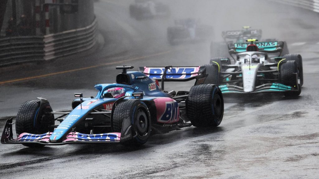 Fernando Alonso, Alpine, heads a train of cars. Monaco, May 2022.