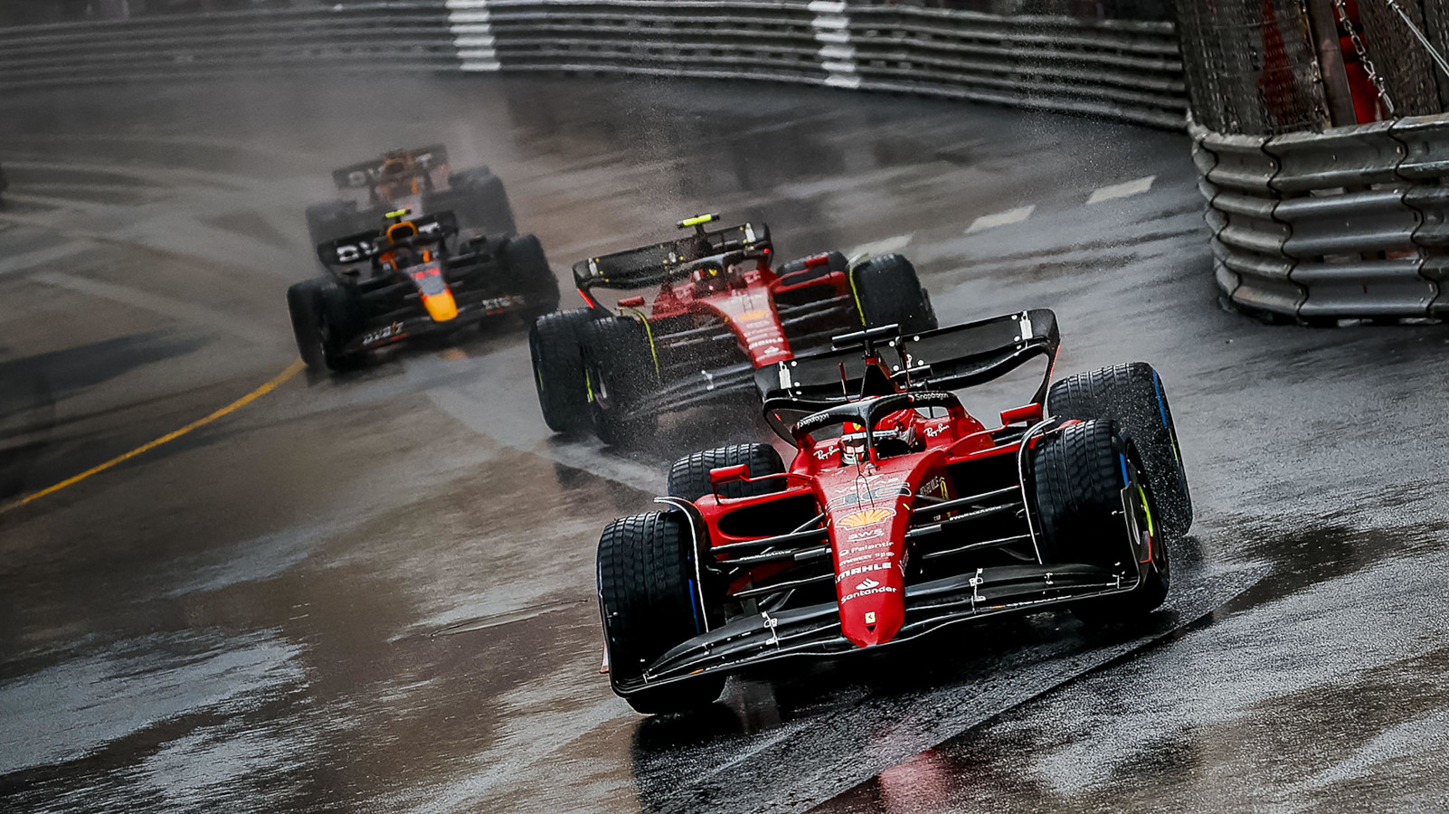 Charles Leclerc leads in the rain, running ahead of Carlos Sainz and the Red Bull drivers. Monaco May 2022