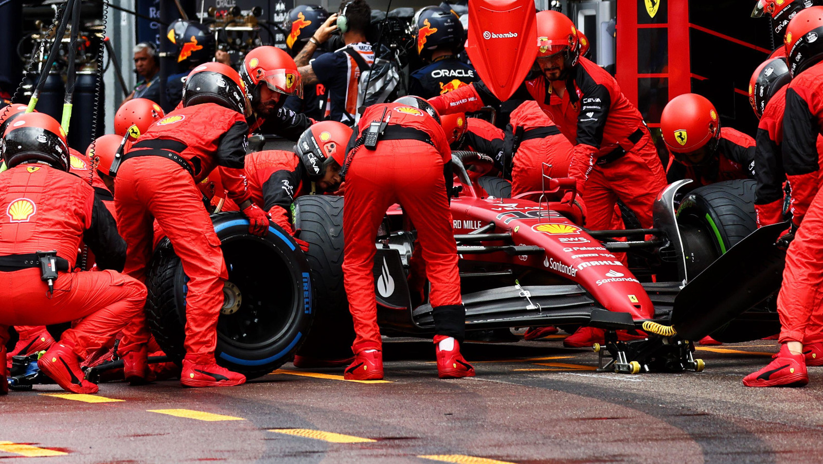 Charles Leclerc pits in his Ferrari garage to swap full wet tyres for intermediates. Monaco May 2022