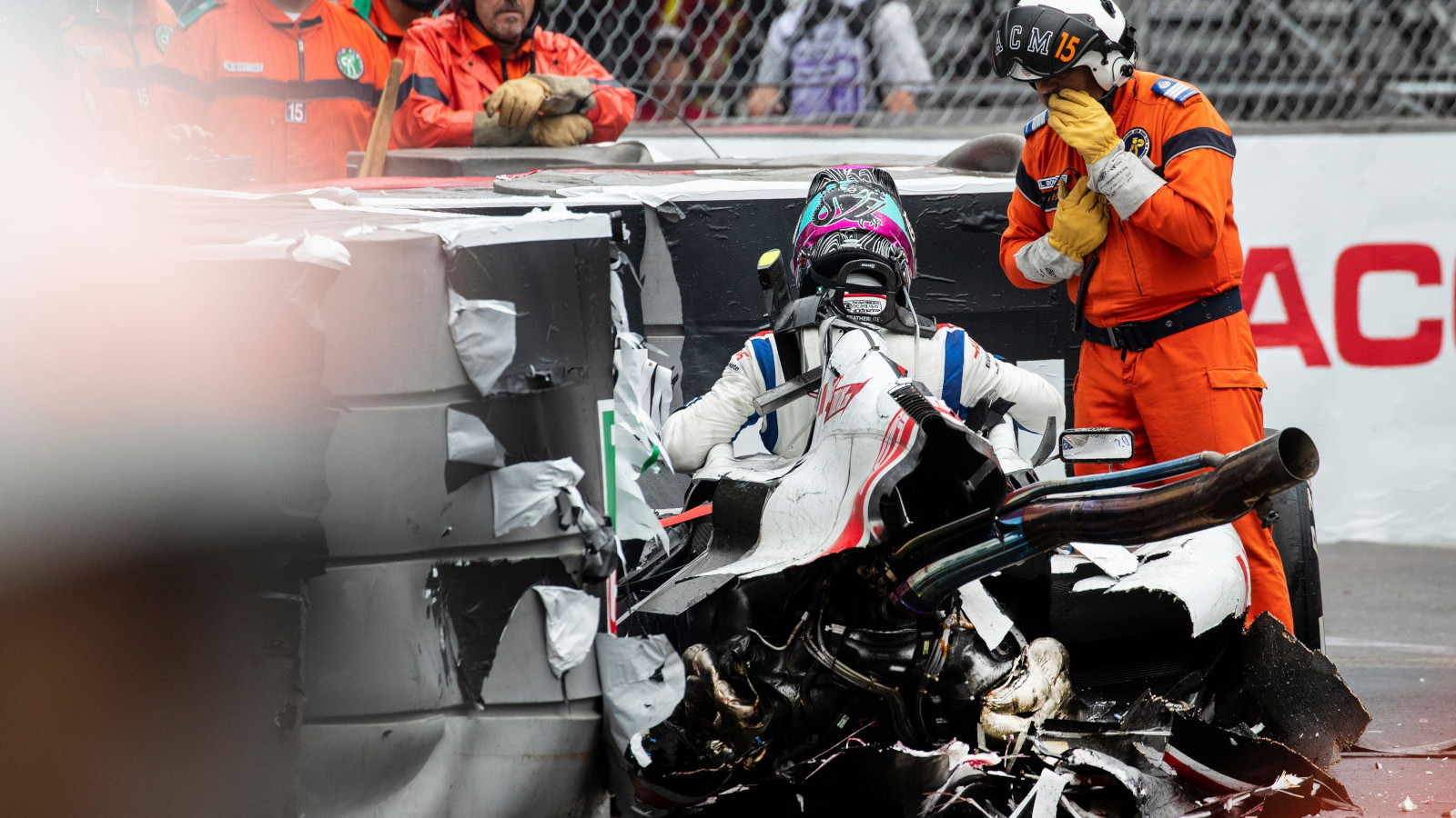 Mick Schumacher climbs out of the wreckage of his Haas VF-22. Monaco May 2022