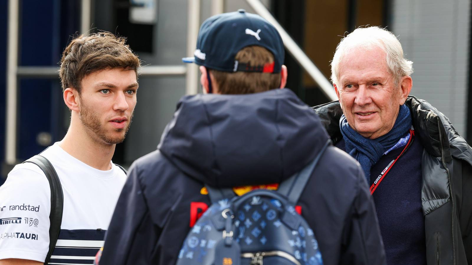 Pierre Gasly and Helmut Marko talking to Max Verstappen. Barcelona February 2022.