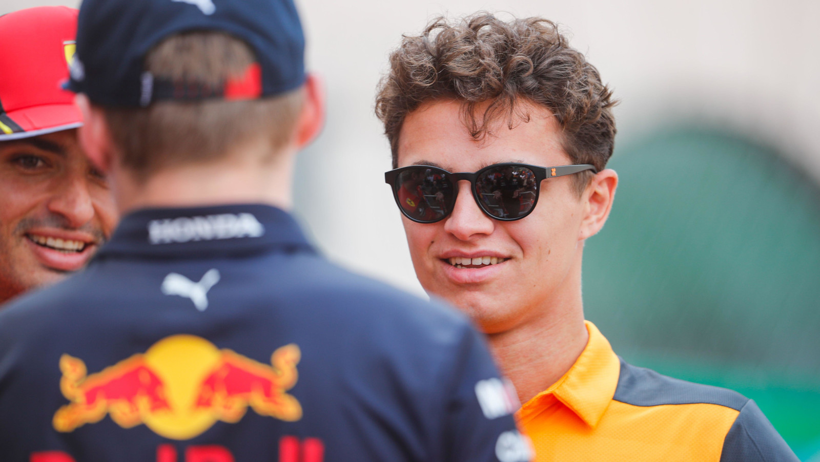 Lando Norris speaking with Max Verstappen and a smiling Carlos Sainz. Monaco May 2022