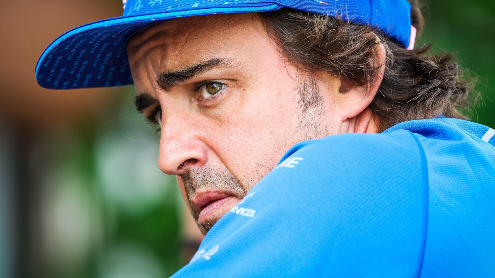 Fernando Alonso looking over his shoulder, serious. Baku June 2022