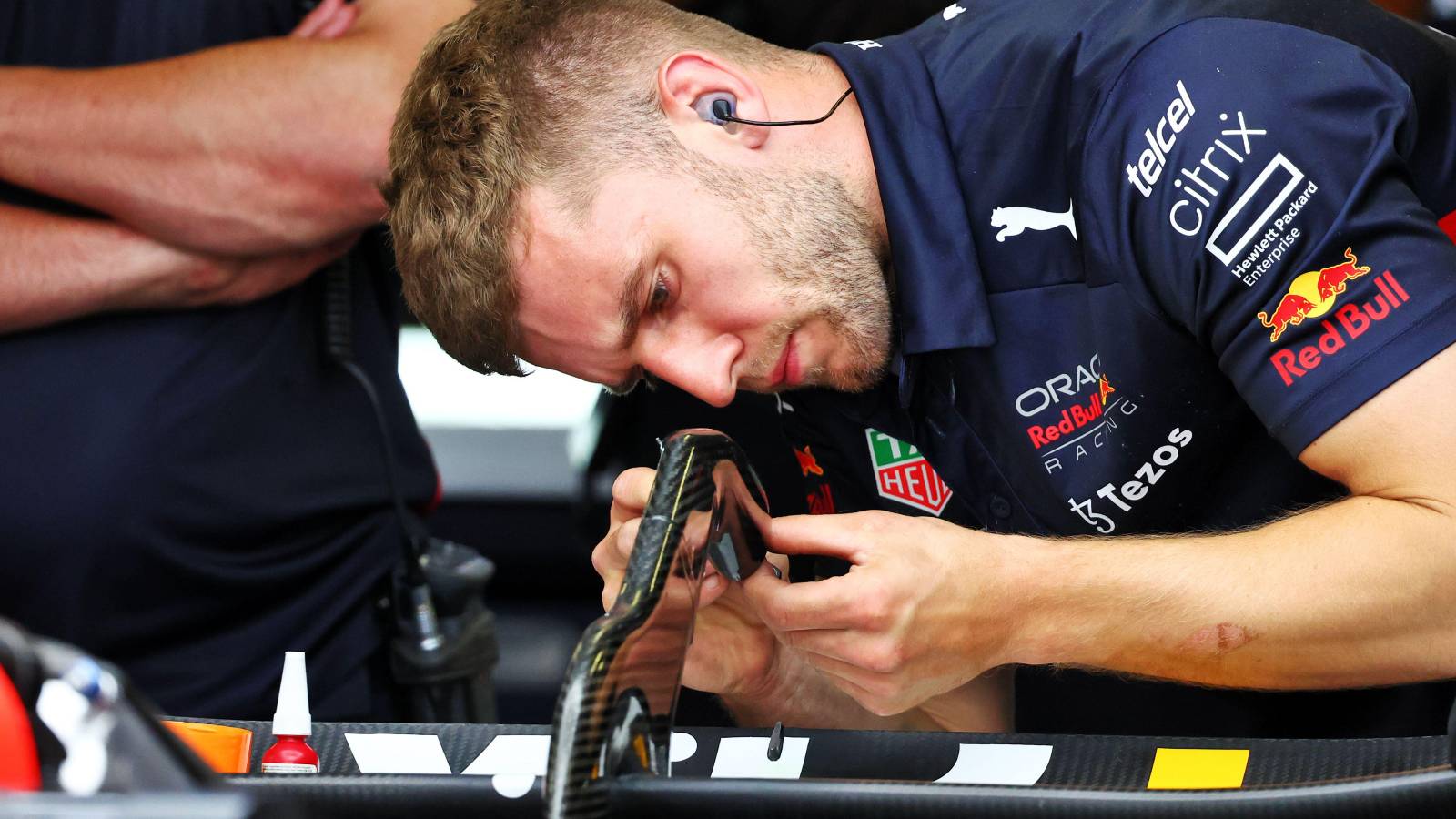 A Red Bull mechanic works on the rear wing. Azerbaijan, June 2022.