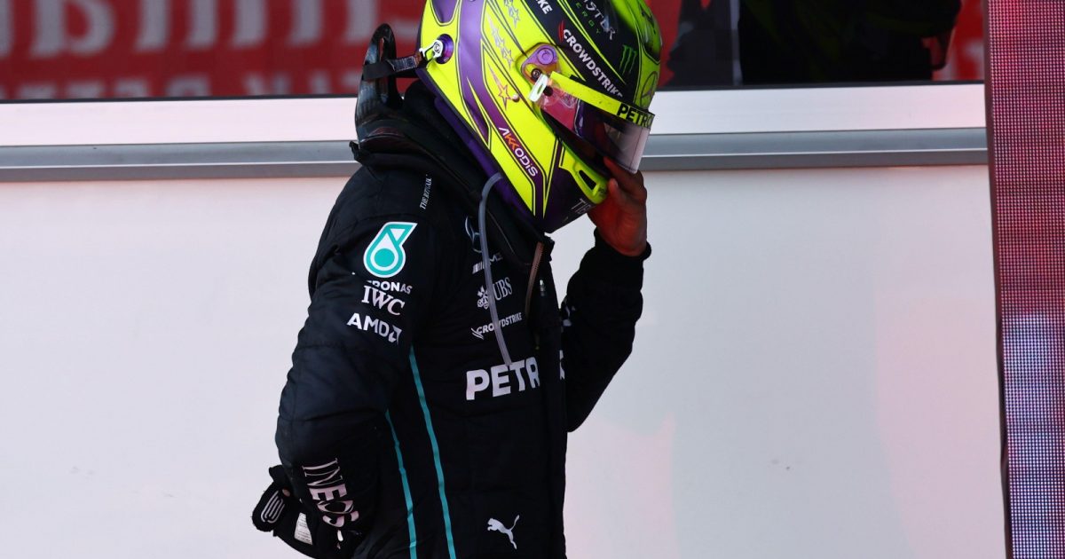 Lewis Hamilton, Mercedes, in pain holding his back. Azerbaijan, June 2022.