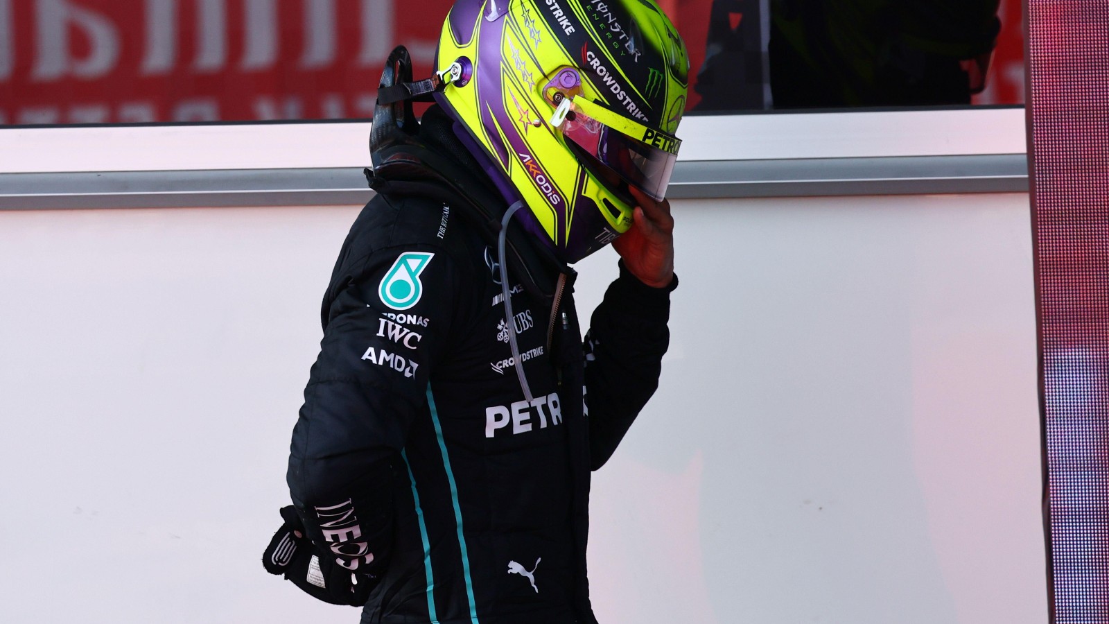Lewis Hamilton, Mercedes, in pain holding his back. Azerbaijan, June 2022.