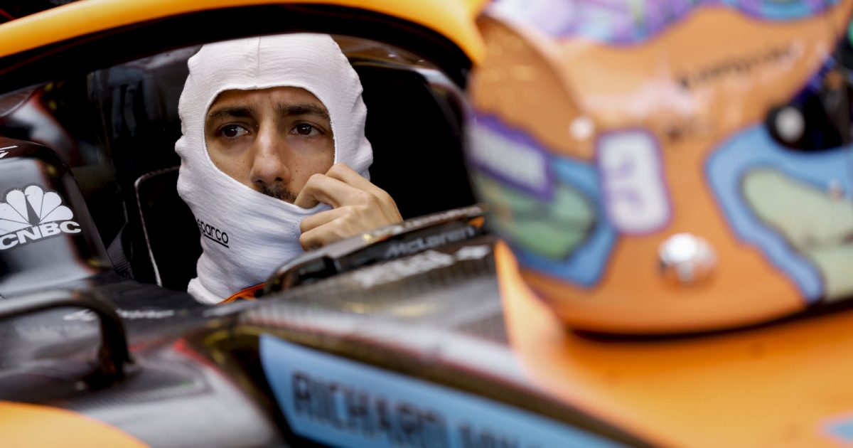 Daniel Ricciardo in the car wearing fireproofs, helmet on the nose. Baku June 2022