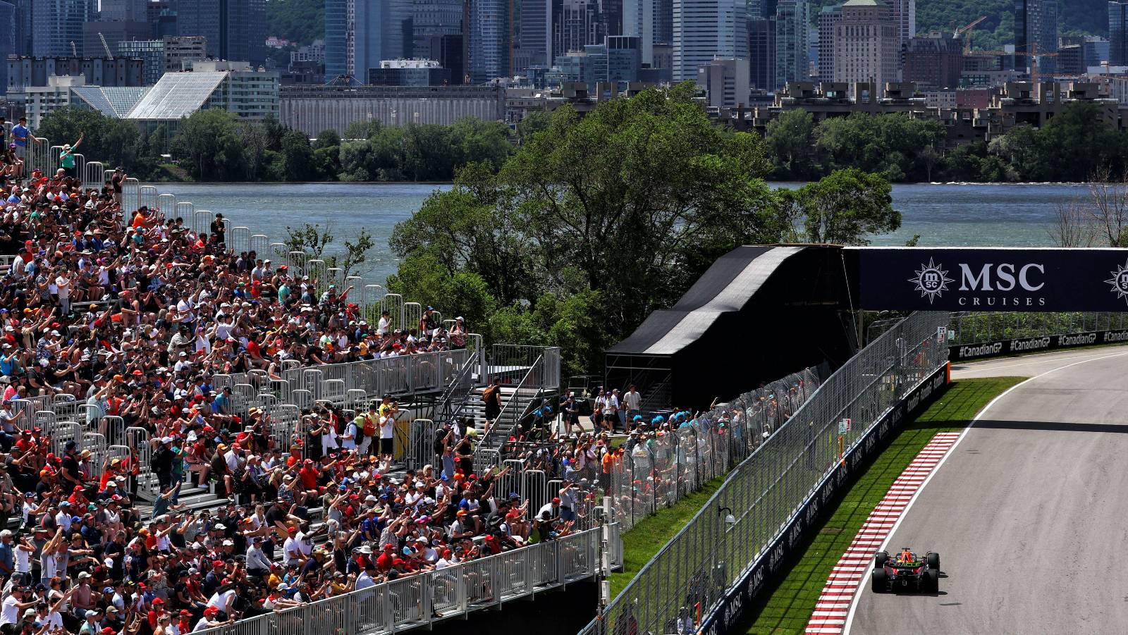 Max Verstappen's Red Bull passes a grandstand at the Canadian GP. Montreal June 2022.