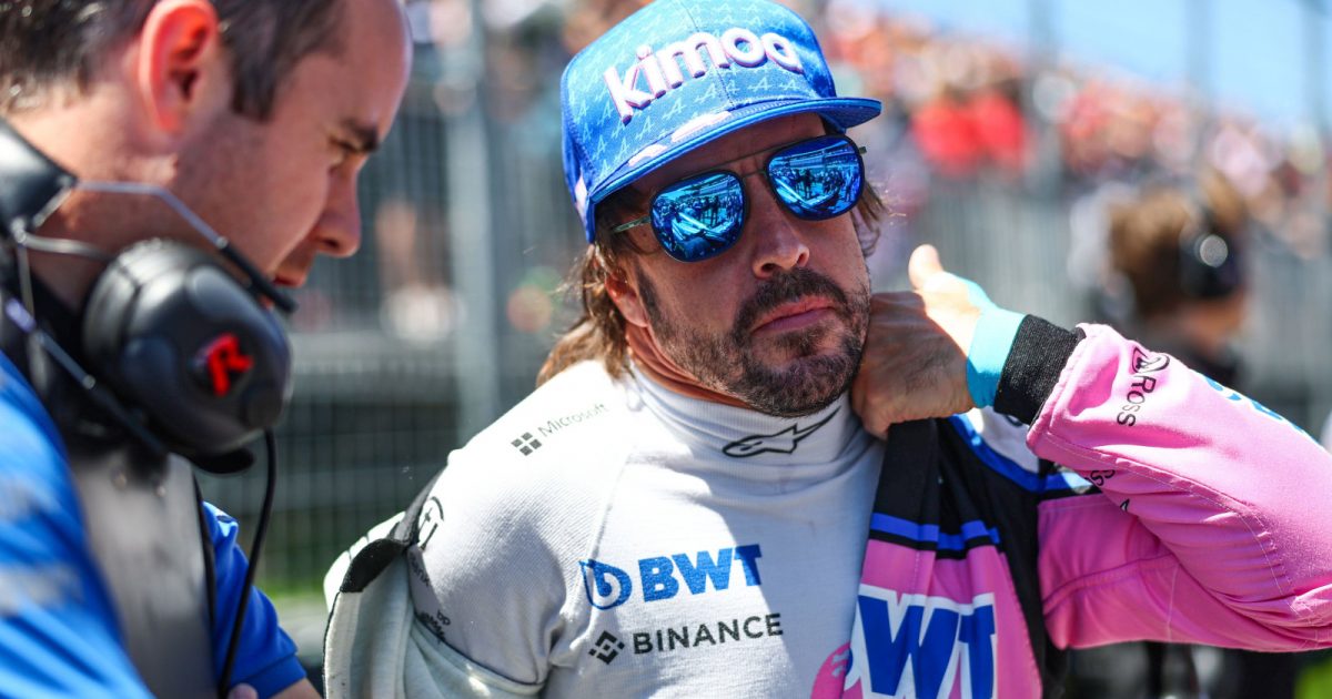 Fernando Alonso putting on his race suit on the grid. Montreal June 2022a
