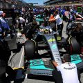 Lewis Hamilton sits in his car on the grid, mechanics present. Montreal June 2022