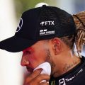 Lewis Hamilton wipes his face with a towel after a grand prix. Bahrain March 2022