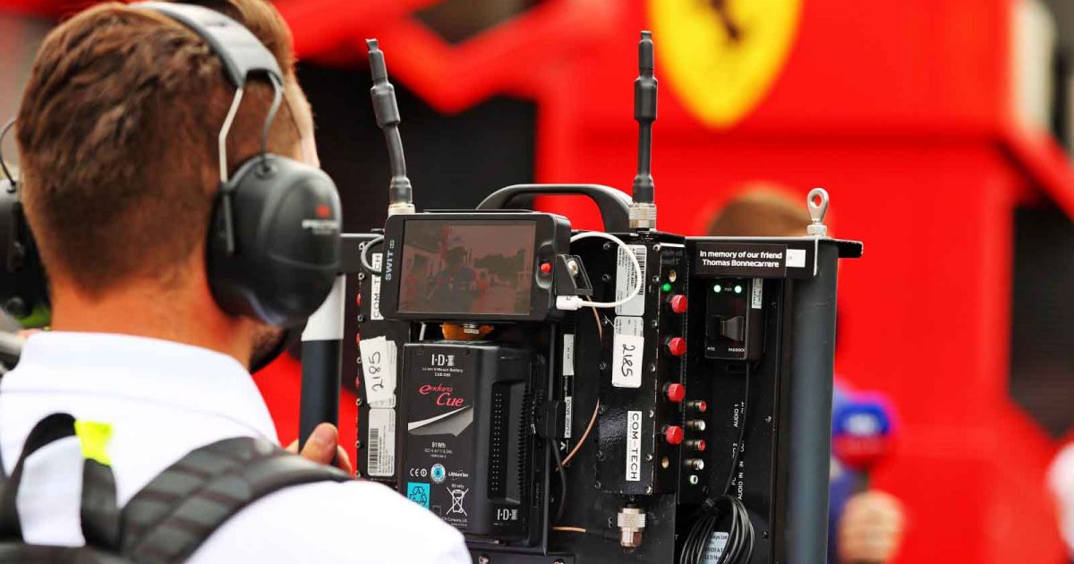 A cameraperson films outside Ferrari. F1 Paul Ricard June 2021.