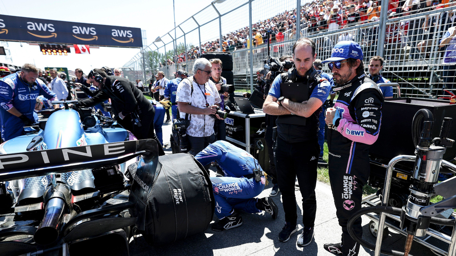 Fernando Alonso on the grid as he mechanics do last minute work on his car. Canada June 2022
