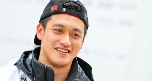 Zhou Guanyu with his cap on backwards, smiling. Britain July 2022