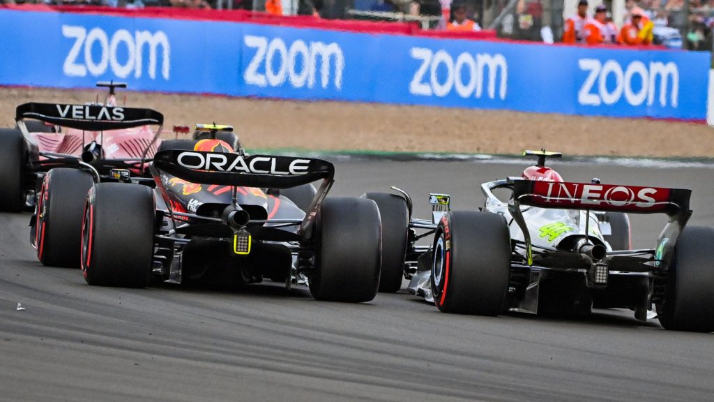 Charles Leclerc racing ahead of Sergio Perez and Lewis Hamilton. Silverstone July 2022