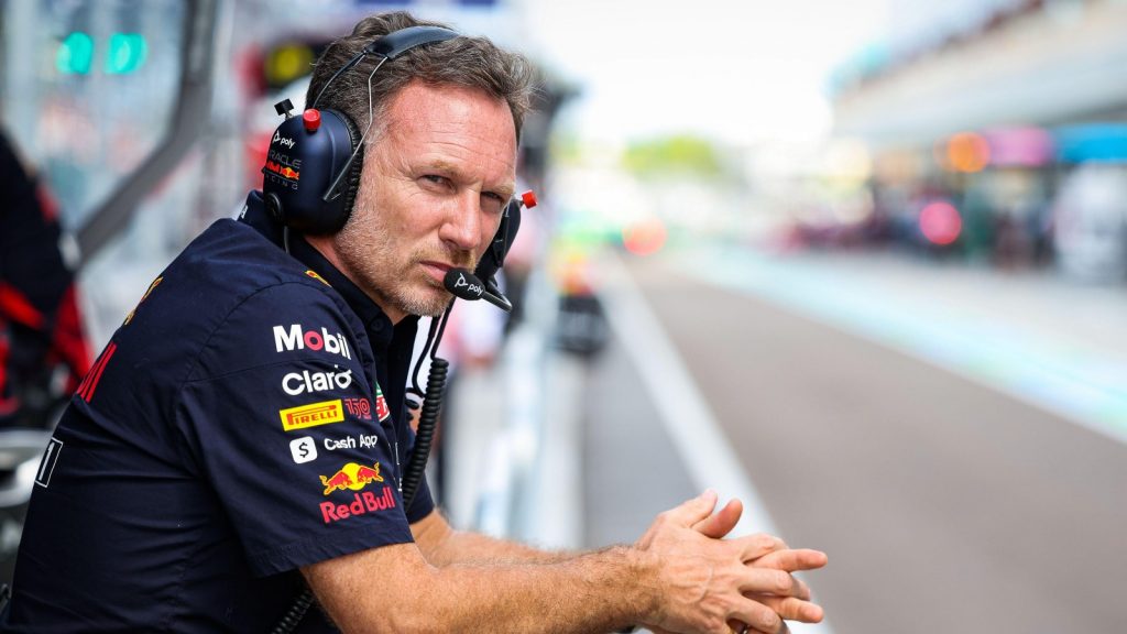 Christian Horner hands folded staring down the pit lane. Miami May 2022