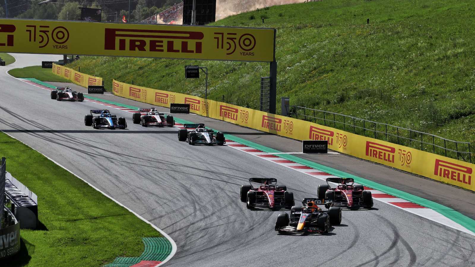 Carlos Sainz and Charles Leclerc, Ferrari, chase Max Verstappen, Red Bull. Austria, July 2022.