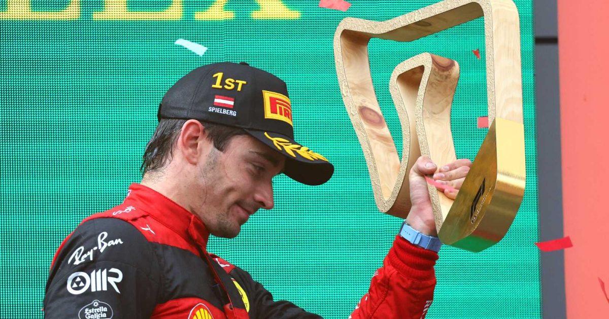 Charles Leclerc, Ferrari, holds up the winners trophy. Austria, July 2022.