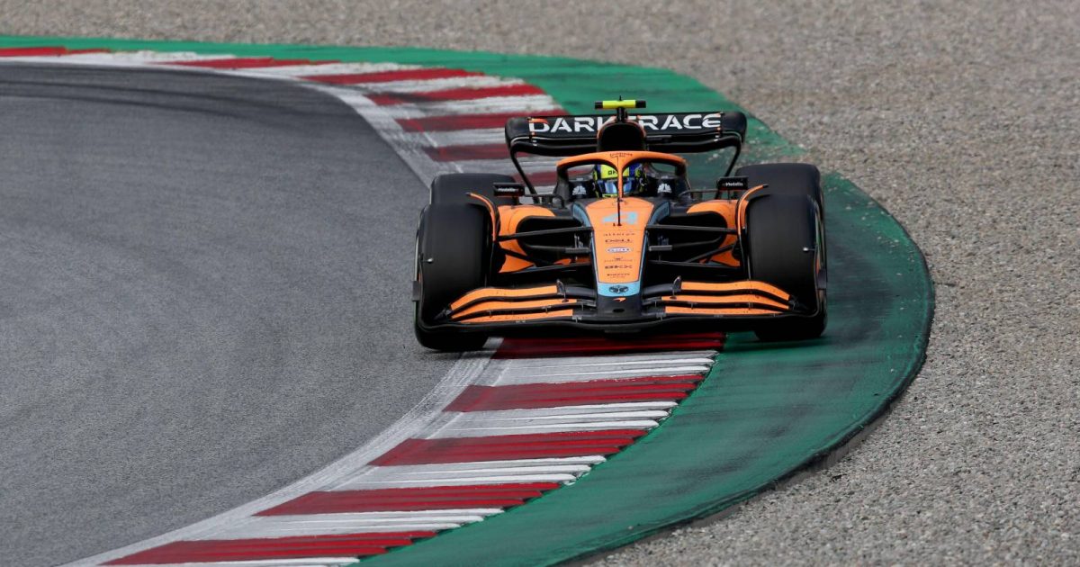 Lando Norris, McLaren, takes plenty of kerb. Austria, July 2022.