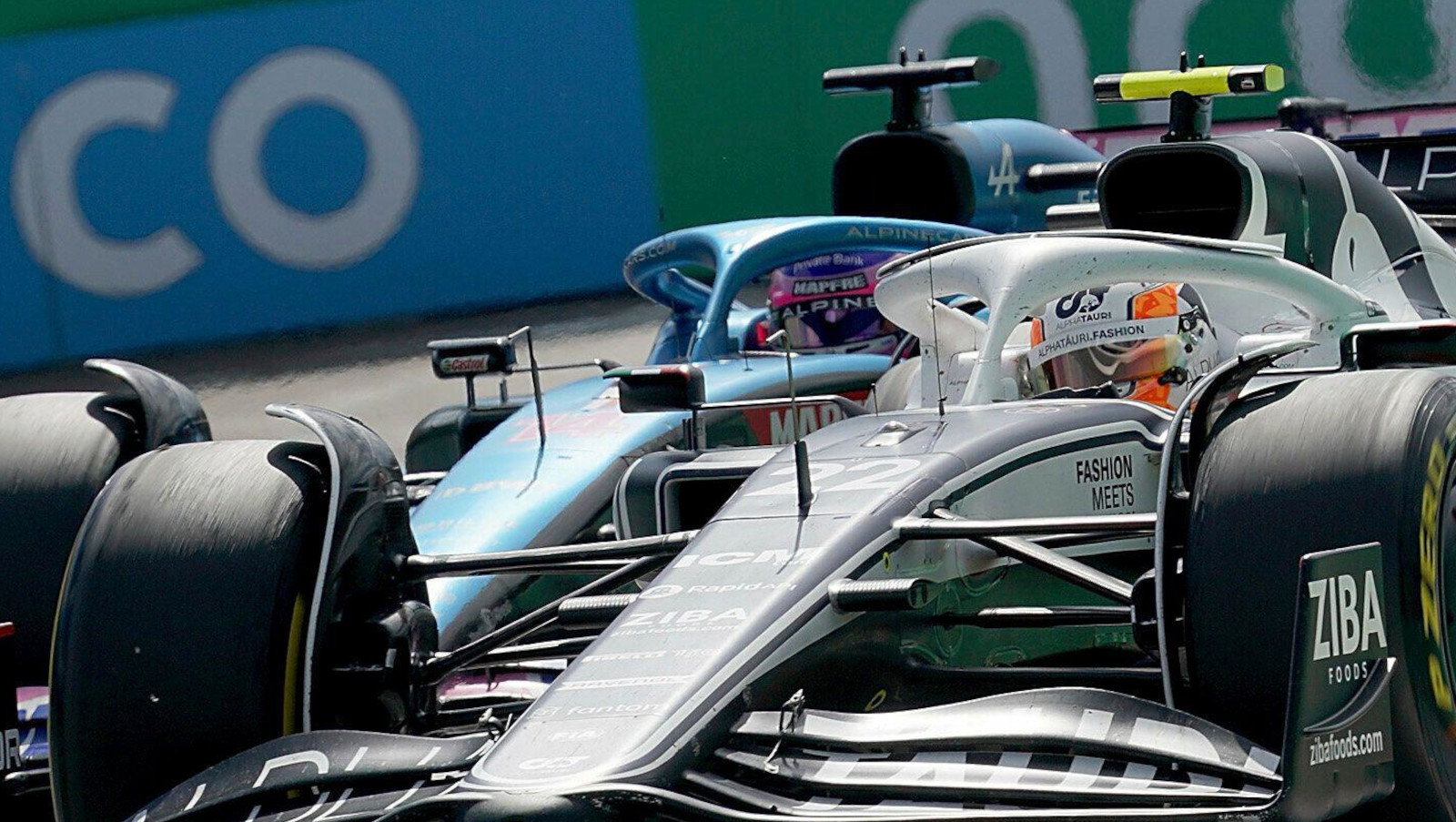 Fernando Alonso racing alongside Yuki Tsunoda. Austria July 2022