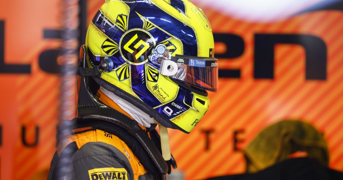 Lando Norris side on in his helmet in the McLaren garage. Austria July 2022