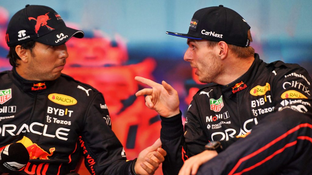 Max Verstappen pointing at Sergio Perez as he explains something. Monaco May 2022