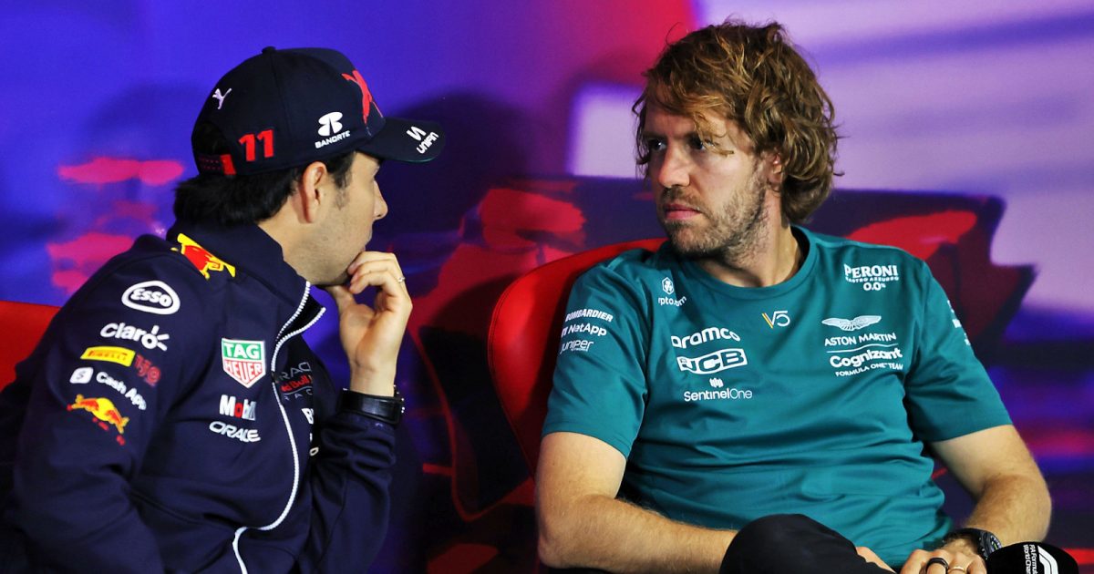Sergio Perez speaking with a serious Sebastian Vettel during a press conference. Silverstone July 2022